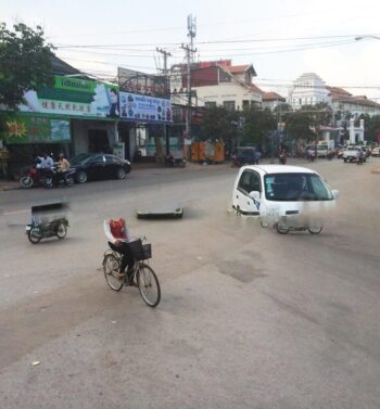 Obviously, a glitch occurred when I took this shot. Check out the headless person on the bike and the white van (without wheels) colliding with a phantom motorbike.