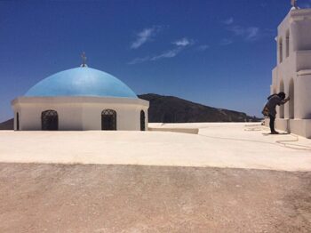 That's Phoebe on a concrete roof in the village of Pyrgos Kallistis. What do you suppose she's aiming at? Gotta love that turquois dome.
