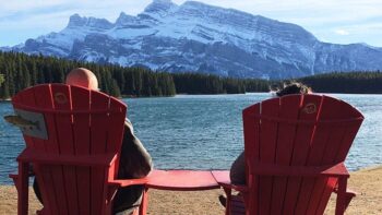 These two visitors to Banff National Park are taking a moment to rest their legs and take in the stunning view.