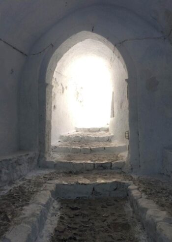 Tucked beneath the Church of the Agia Triada (Holy Trinity) in Pyrgos Village is this beautiful monastic chamber with whitewashed walls and white stone steps. Looks like an upward journey into heaven, doesn't it?