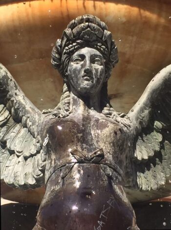 This bronze angel with a stoic expression is doing a splendid job of supporting a huge fountain bowl with her wings, but she doesn't look very happy about it. Shhhhhhh, she's concentrating!