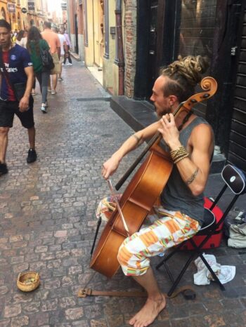 Who doesn't like a barefoot cellist in France with his dreads pulled up in beehive?
